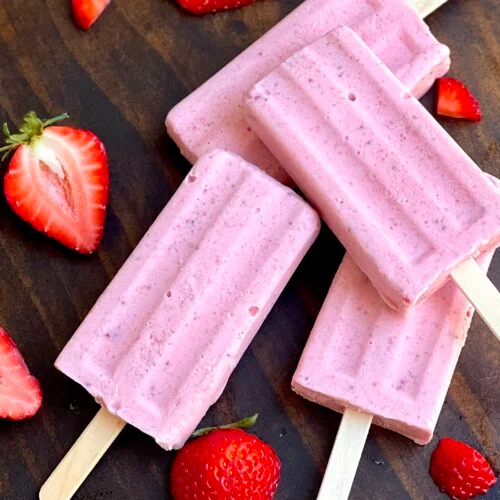 Handmade strawberry cream paletas with fresh strawberries